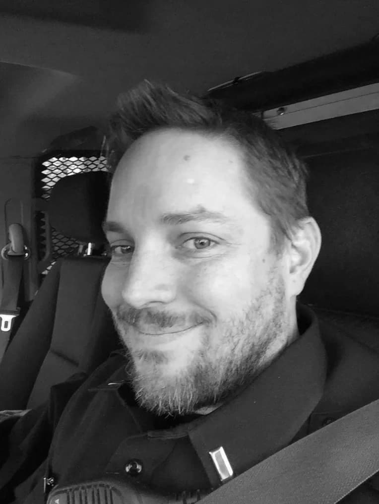 Shane working in a patrol car